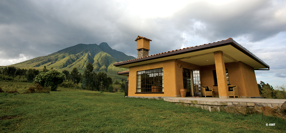 A lodge with a mountain in the background.