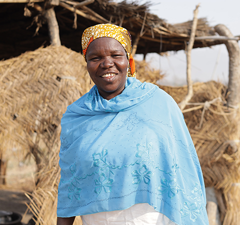 Hauoa Laraba stands infront of her kitchen in Tchamba, Faro Landscape