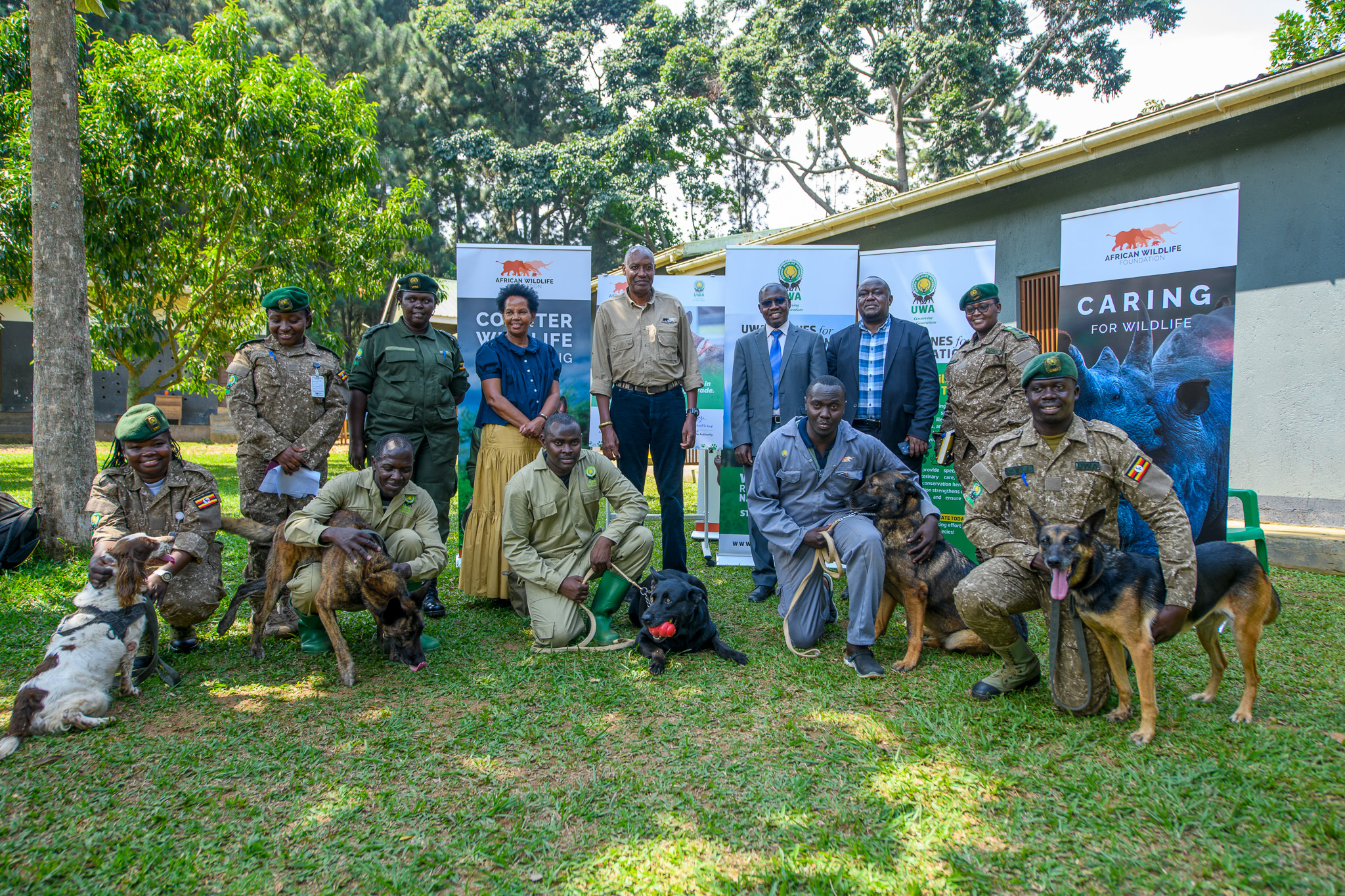 AWF CEO Kaddu Sebunya, AWF Uganda Country Director Rose Ssebatindira, and Uganda Wildlife Authority Representatives during the program transition ceremony for the Canine Units in Uganda.