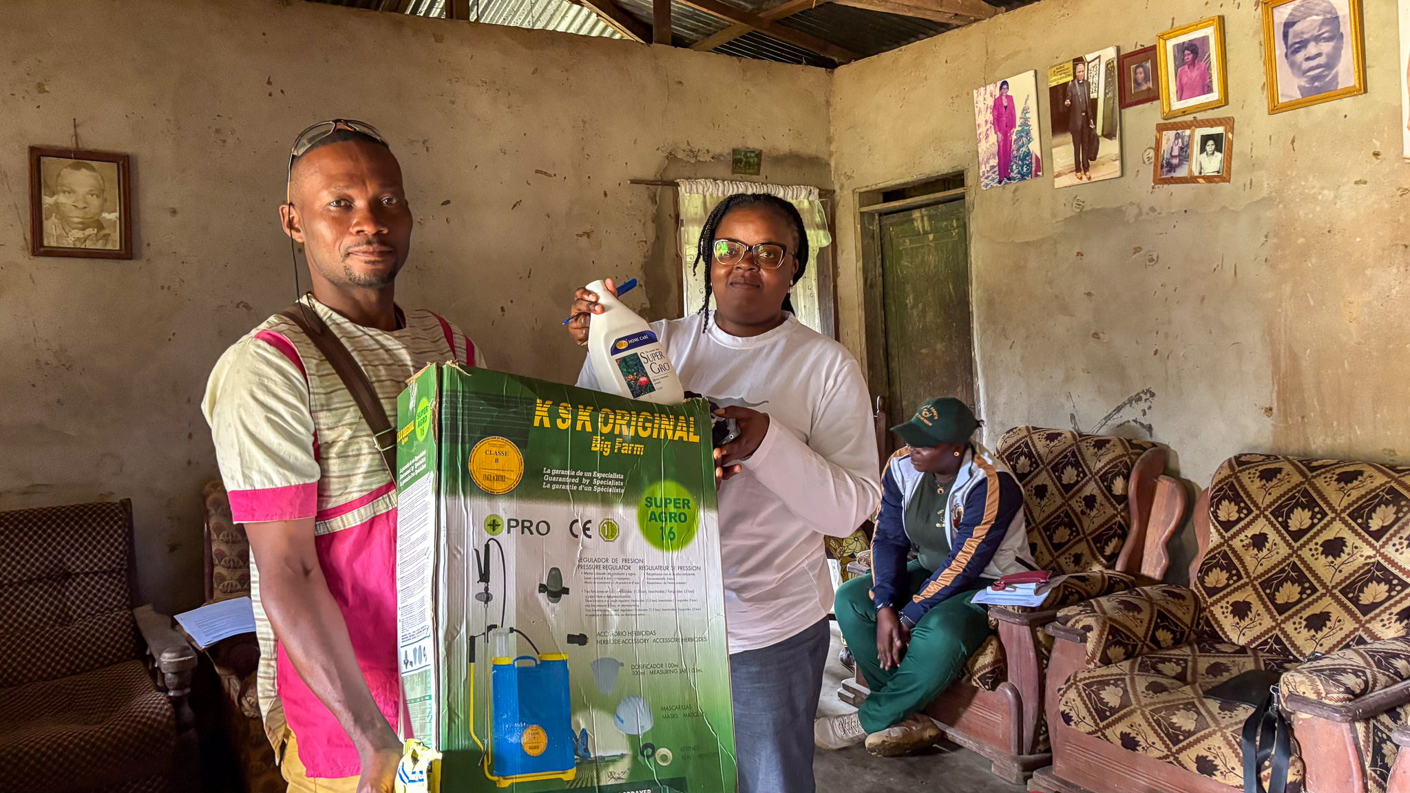 Yves receives advanced farming equipment from AWF Community Liaison Lydie Nguesse in recognition of his impressive work under the project.