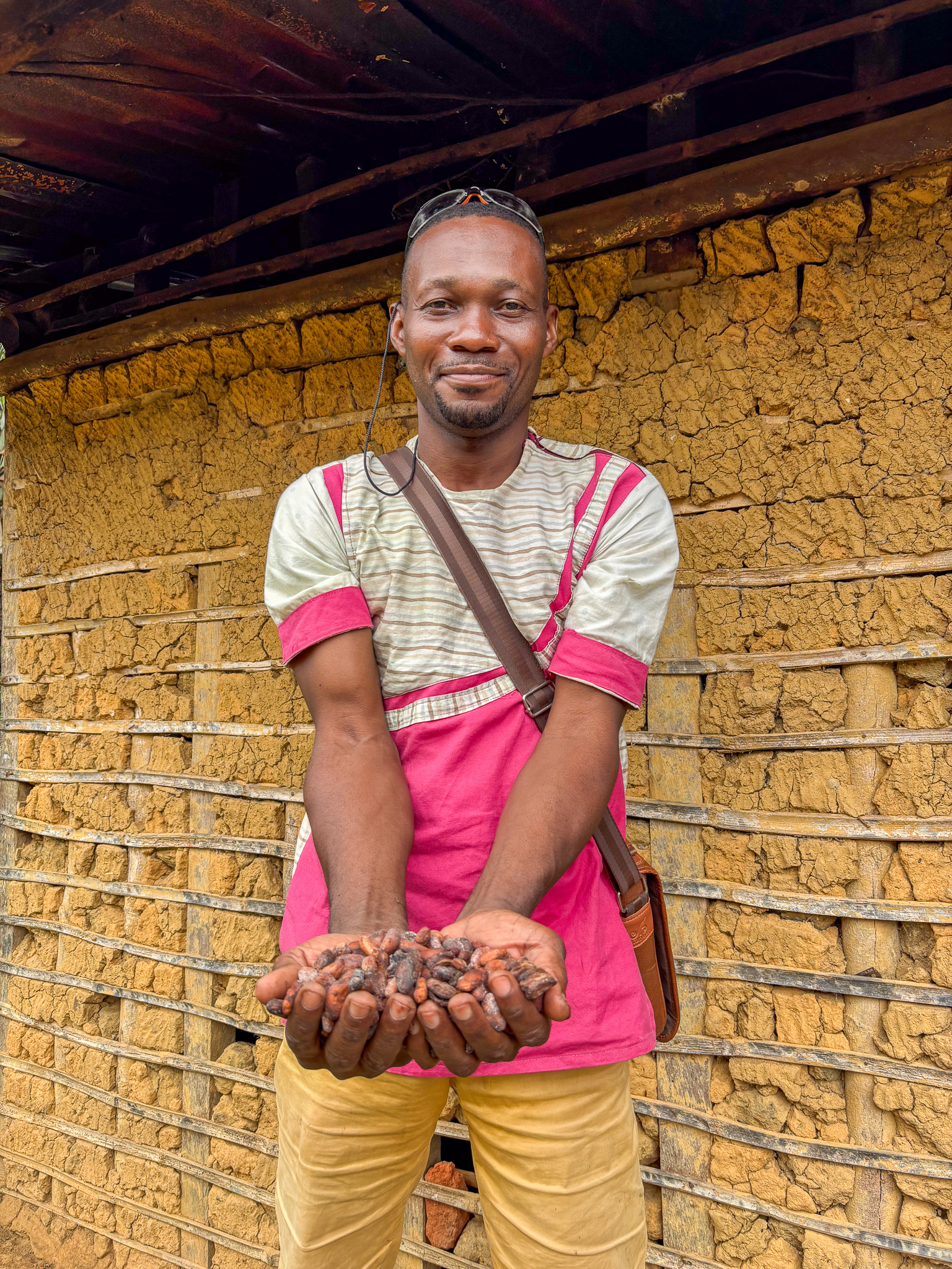 Yves showing off part of his cocoa harvest from the previous cocoa season.