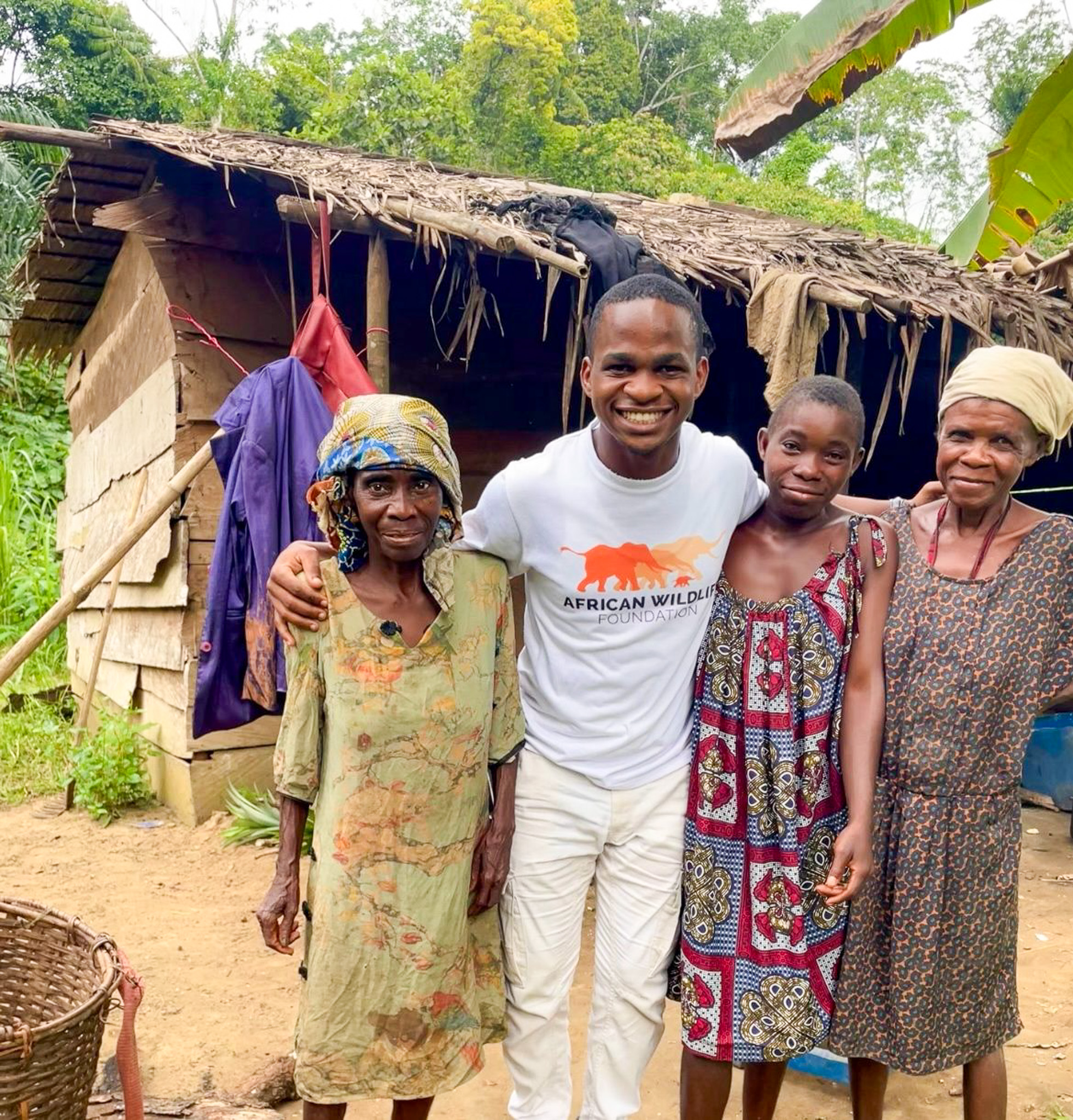 Yann Avoto (center), AWF Biomonitoring assistant based in Campo stands alongside Indigenous Bagyeli women.