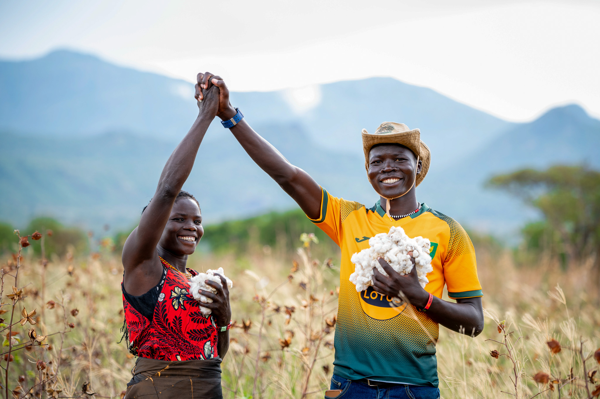 Cotton farmers Victor Bari and Hellen Nakwang celebrating the harvest on their farms.