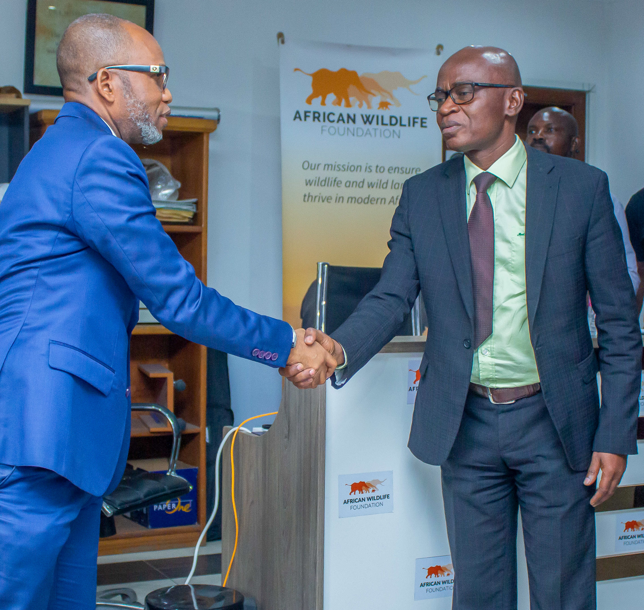 ICCN Director General Yves Milan Ngangay shakes hands with AWF DRC Country Coordinator Antoine Tabu.