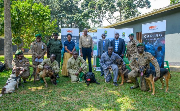AWF CEO Kaddu Sebunya, AWF Uganda Country Director Rose Ssebatindira, and Uganda Wildlife Authority Representatives during the program transition ceremony for the Canine Units in Uganda.