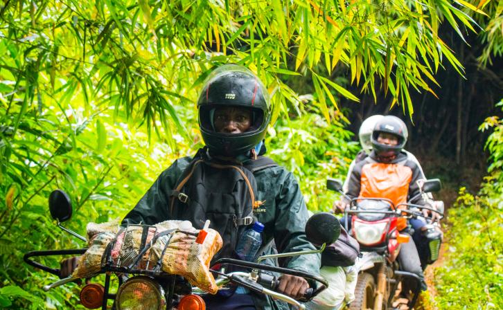 Motorcycle rider Jeancy Luaka navigates through the dense Lomako-Yokokala Faunal Reserve.