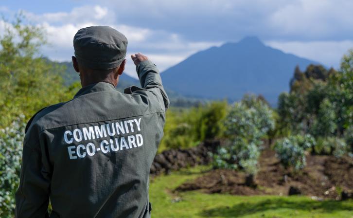 A Community Eco-Guard surveys the Virungas Landscape.