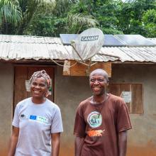 Clautilde and Sere Etienne stand infront of their Solar powered home, Dja, Cameroon.